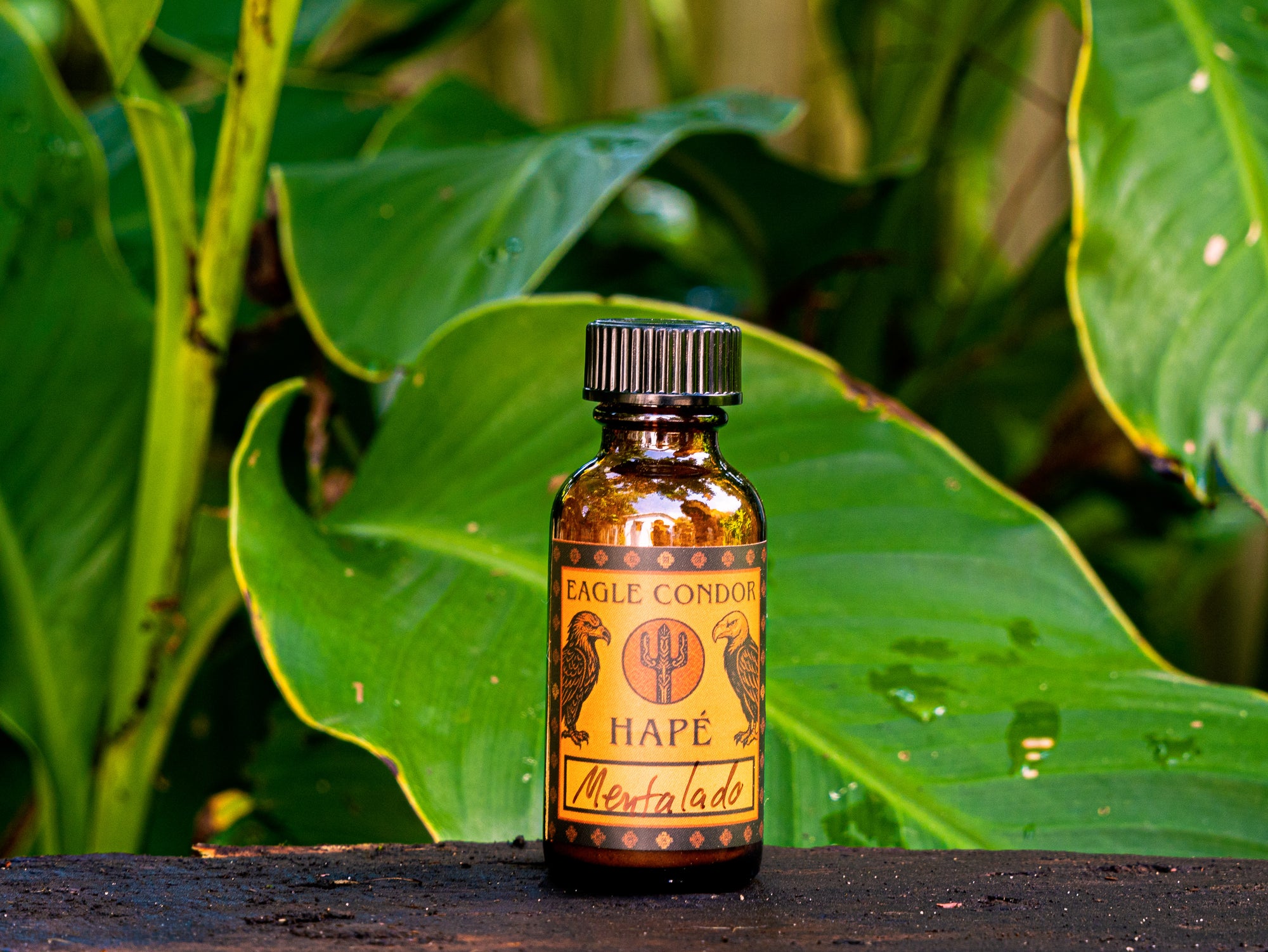 Bottle of Eagle Condor Hape Mentolado against a green leafy background