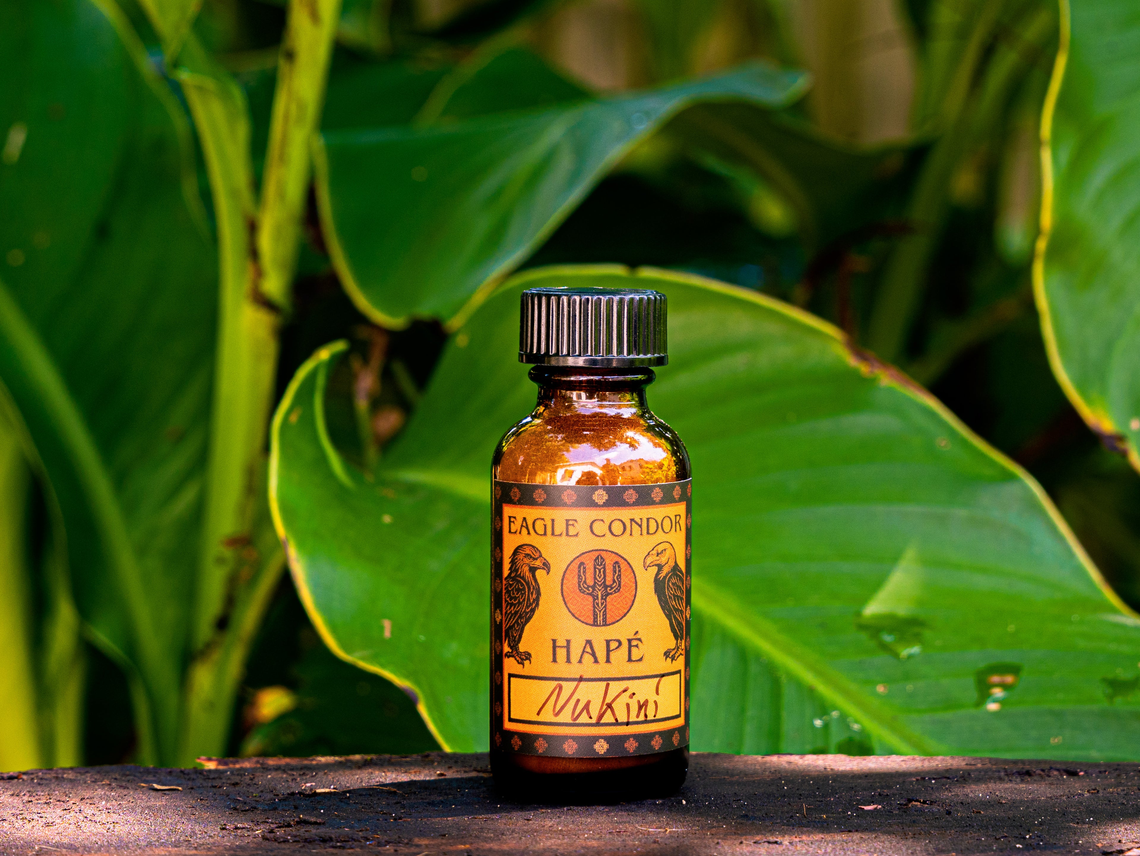 Bottle of Eagle Condor Nukini Hape against a green leafy background