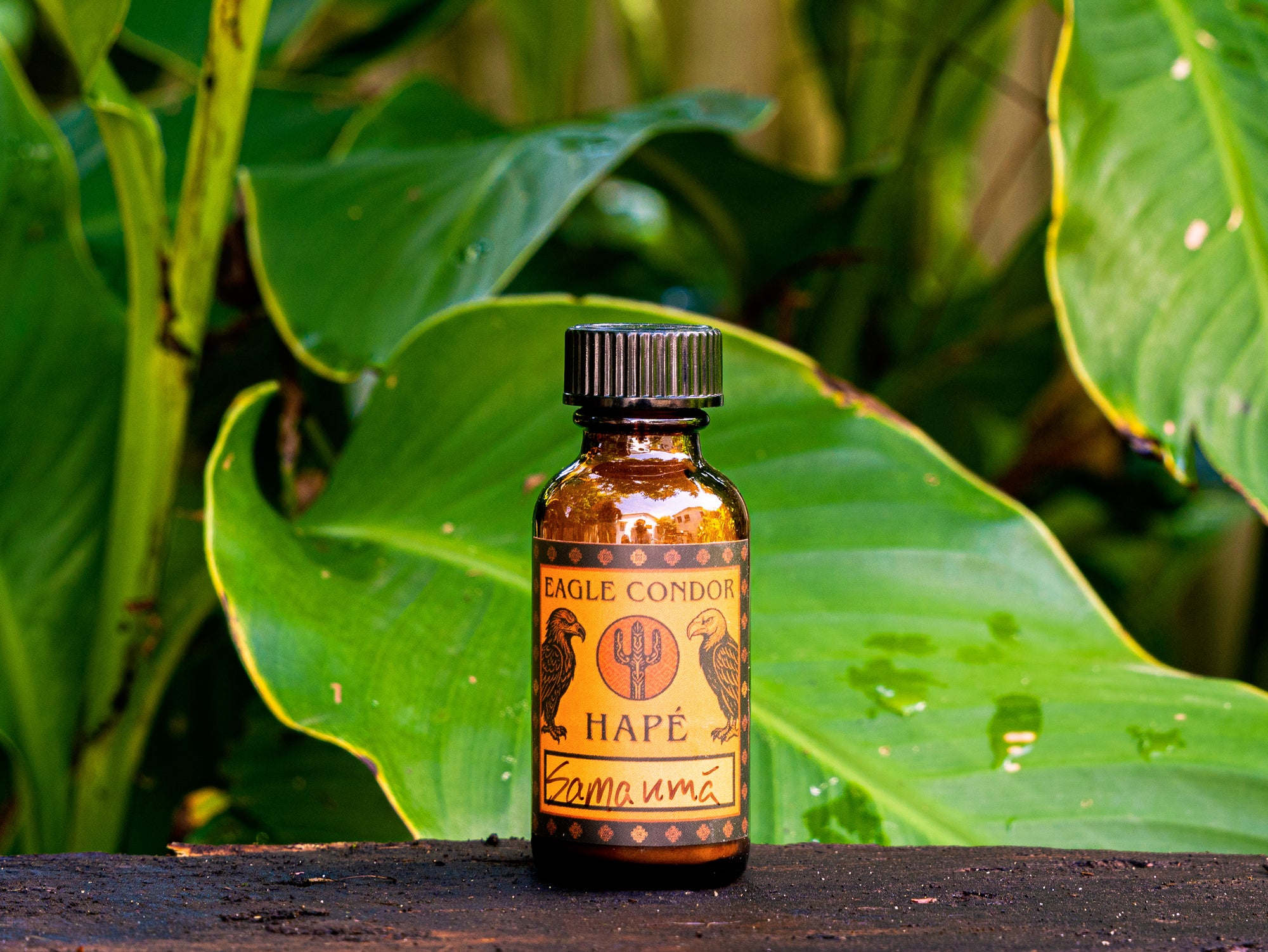 Bottle of Eagle Condor Hape on a wooden surface with green leaves in the background